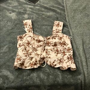 Cream sleeveless tank top with sweetheart neckline and ruched ruffled style